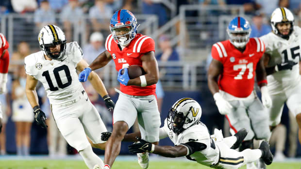 Oct 28, 2023; Oxford, Mississippi, USA; Mississippi Rebels running back Quinshon Judkins (4) runs the ball as Vanderbilt Commodores defensive back Savion Riley (21) dives to make the tackle during the first half at Vaught-Hemingway Stadium. Mandatory Credit: Petre Thomas-USA TODAY Sports